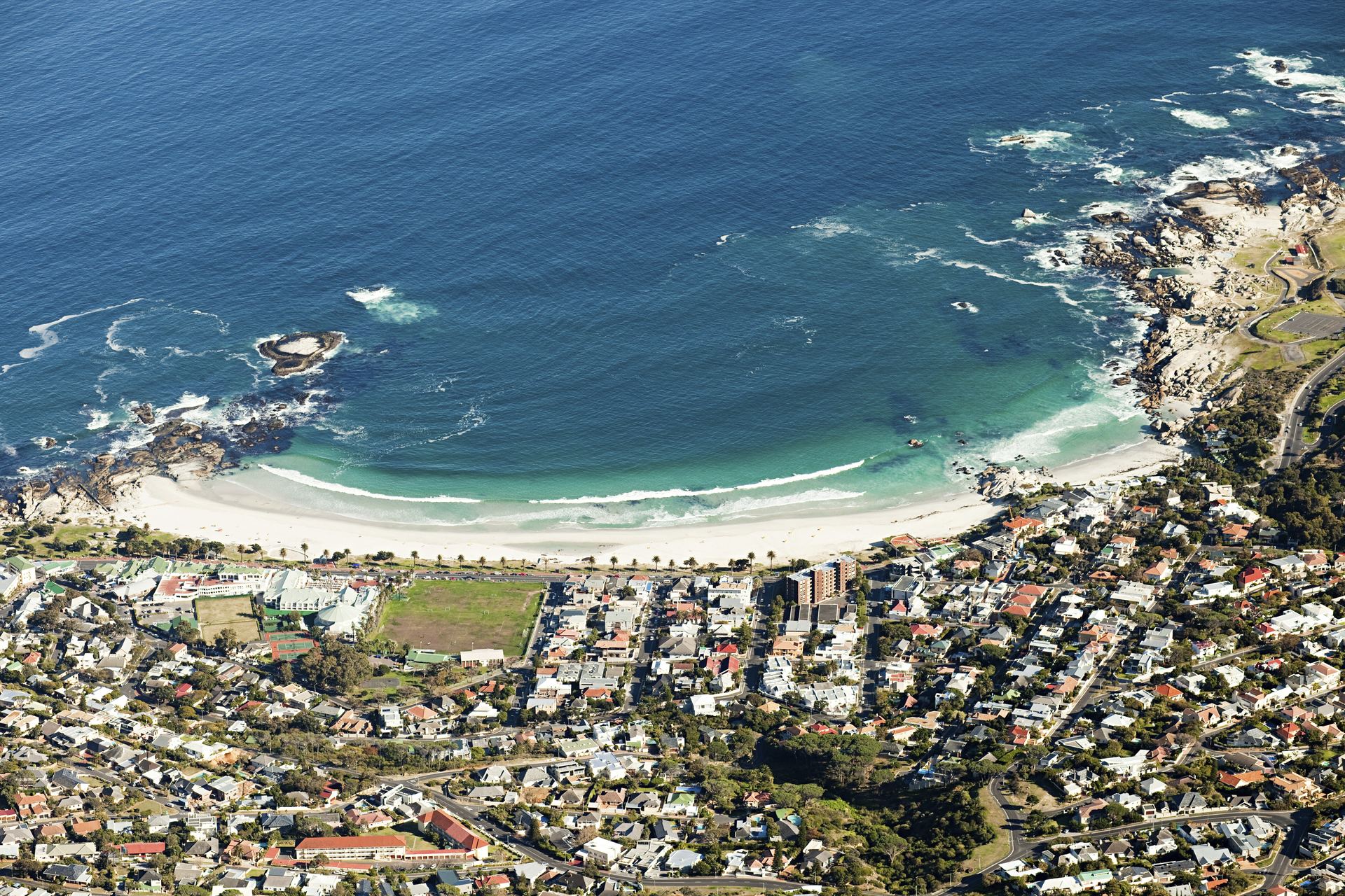 Camps Bay beach and the coastal road seen from high on Table Mountain.
