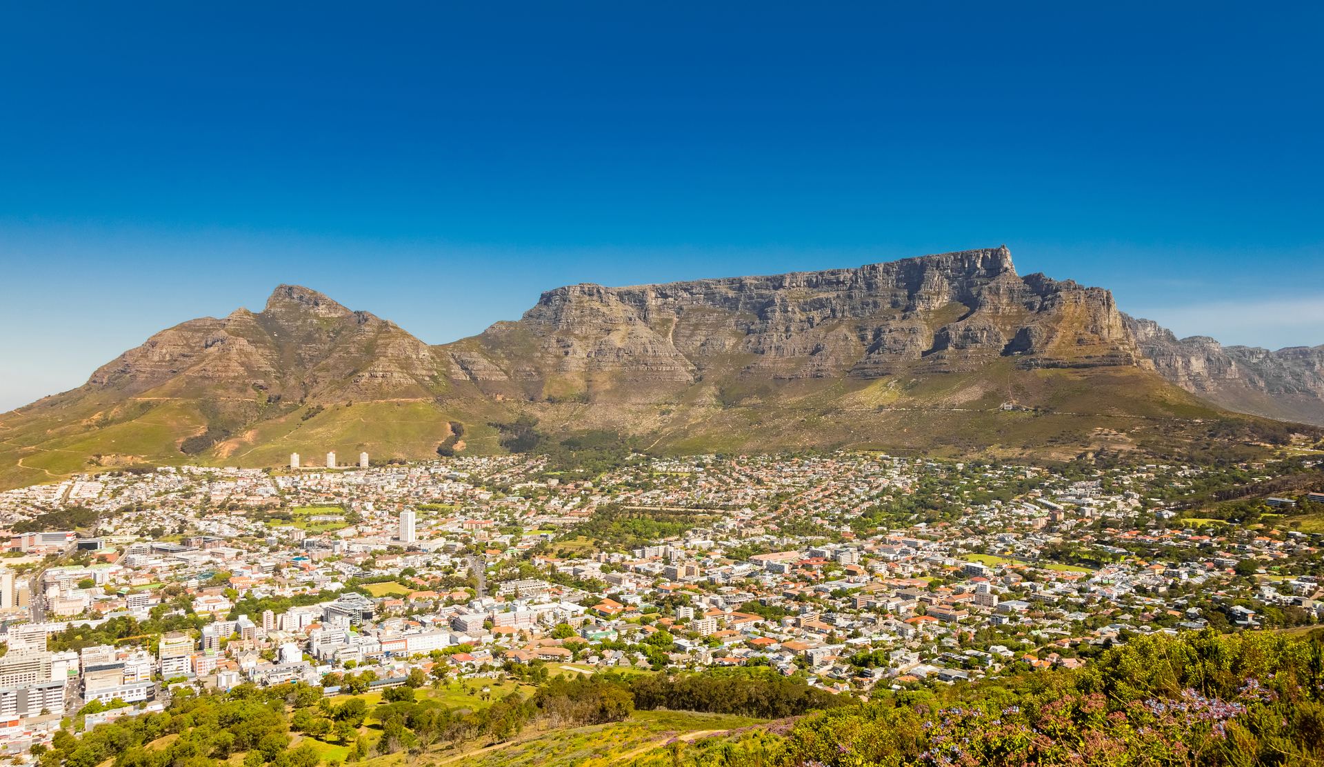 Cape Town spread beneath the rocky mountain range on a clear day.