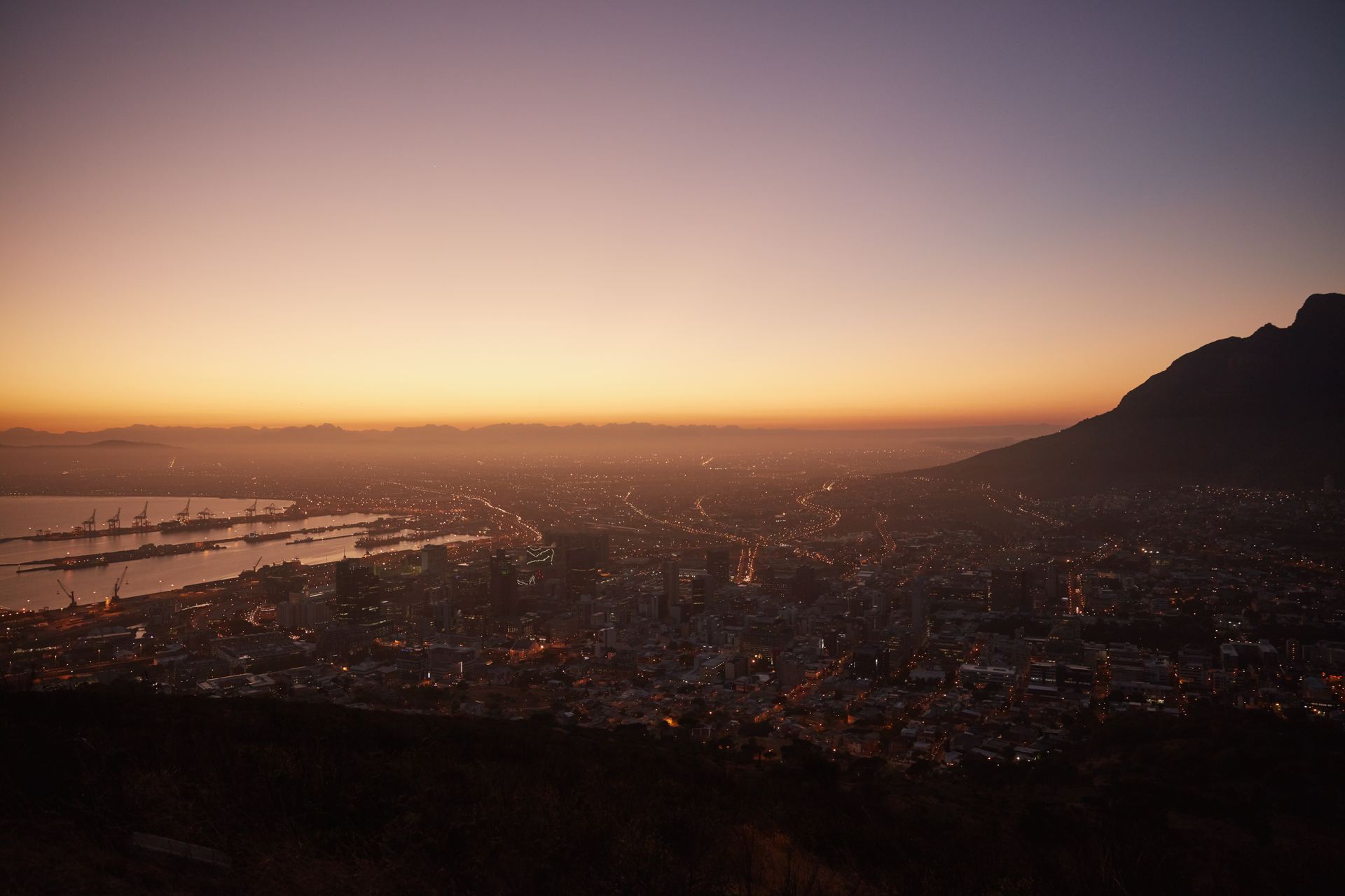 Cape Town city and harbour at golden hour, seen from above.