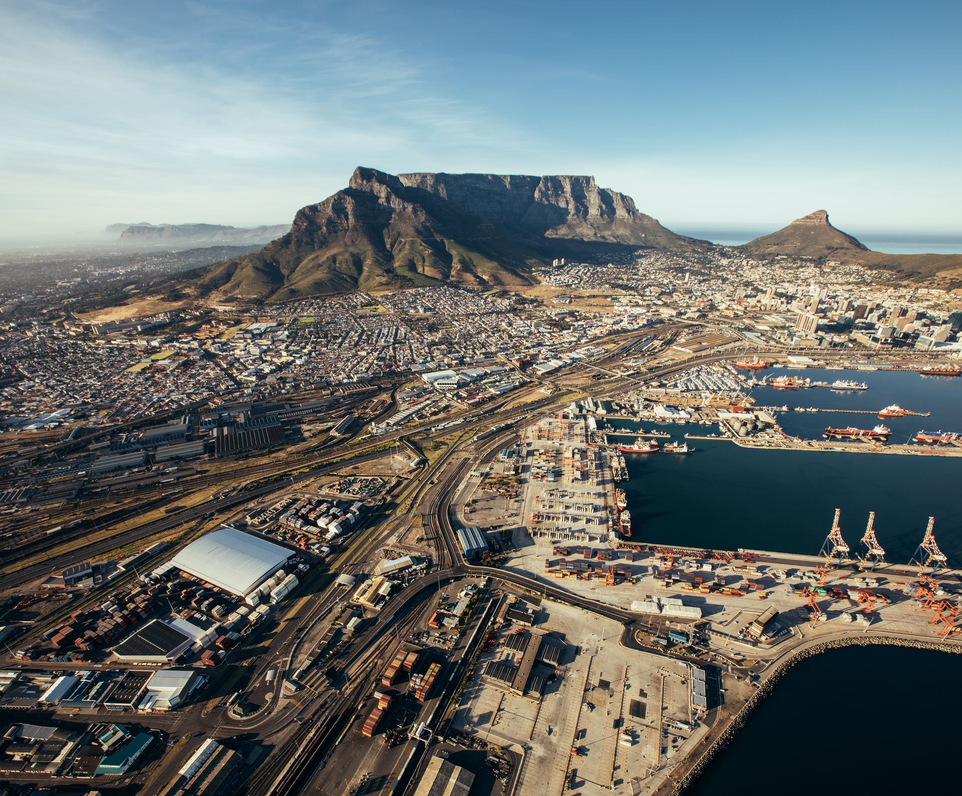 Aerial view of Cape Town with the working port, rail yards and the city below Table Mountain.